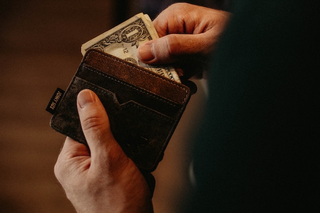 Man removing money from wallet