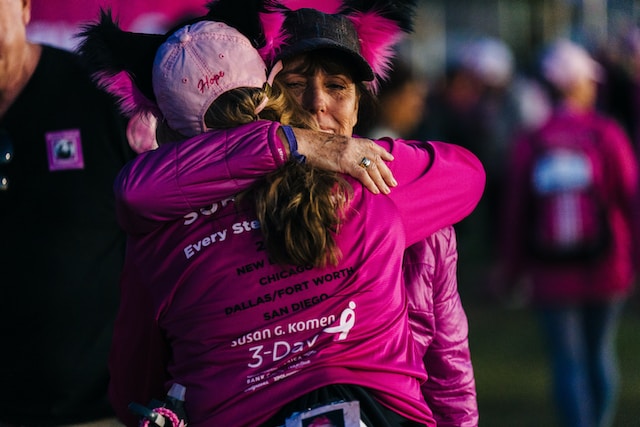 Runners hugging at Susan G. Komen marathon