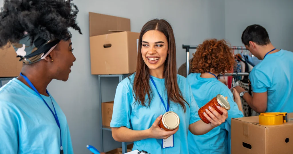 A group of diverse volunteers smiling and working together on a project